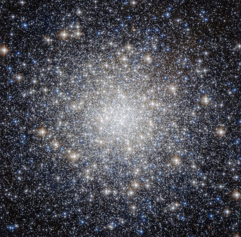 Photo of globular cluster M92, showing a dazzling array of stars that increase in density until individual stars cannot be seen at its bright core and appear as a sort of fog.
